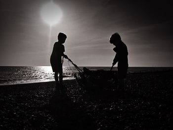 Full length of woman on beach at sunset