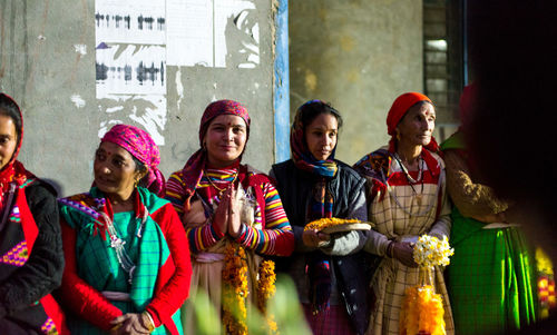 Group of people standing against wall in city