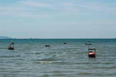 View of boats in sea against sky