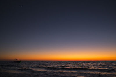 Scenic view of sea against clear sky during sunset