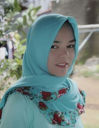 Close-up portrait of young woman in hijab outdoors