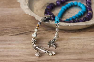 Close-up of necklace on wooden table