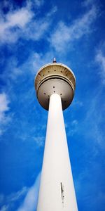 Low angle view of communications tower against sky