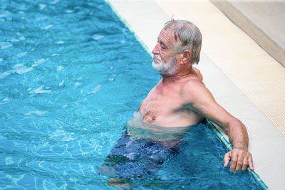 High angle view of man swimming in pool