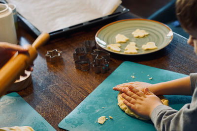 Cropped hands of person preparing food on table