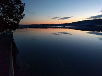 Scenic view of lake against sky at sunset