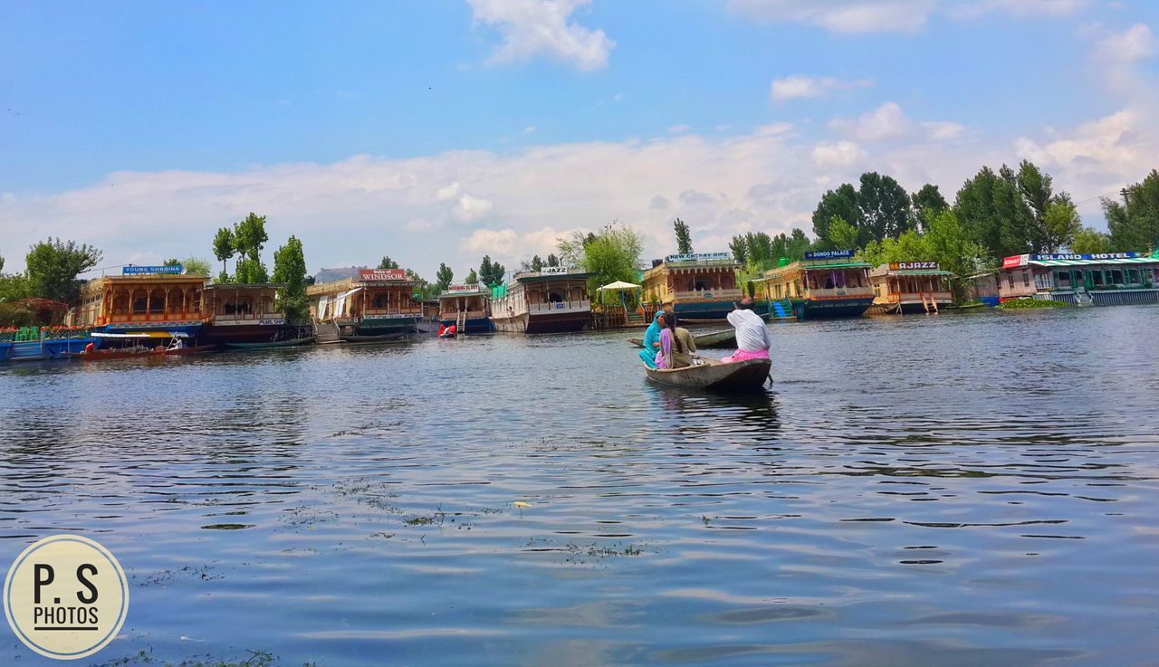 BOAT MOORED ON RIVER AGAINST SKY