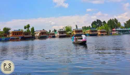 Boats moored on river against sky