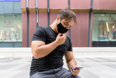 Full length of man using mobile phone