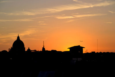 Silhouette of building against sky during sunset