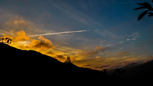 Low angle view of silhouette mountain against sky during sunset
