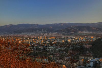 Aerial view of cityscape against sky at night