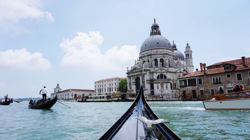 People on gondolas sailing in grand canal by santa maria della salute