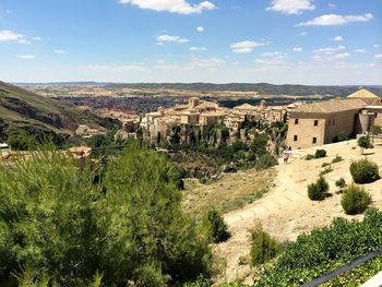 Panoramic shot of plants and buildings against sky