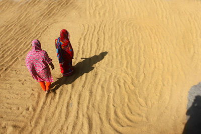 High angle view of women on sand at beach