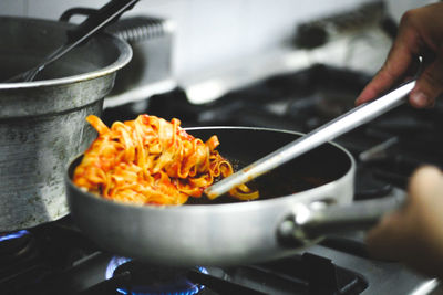 Close-up of person preparing food in kitchen at home