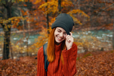 Beautiful young woman in hat during autumn
