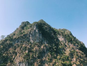 Low angle view of mountain against clear blue sky