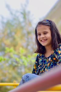 Portrait of smiling girl against blurred background