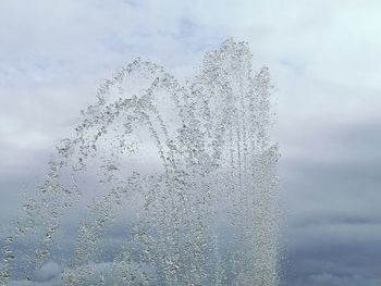 Close-up of water splashing against sky