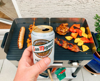 Midsection of person holding food on table