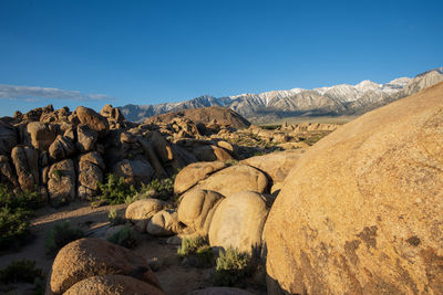 Panoramic view of rocks and mountains against blue sky