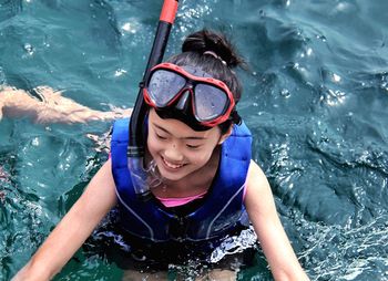 Portrait of smiling boy swimming in sea