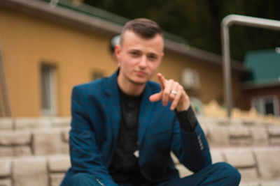 Young man sitting outdoors