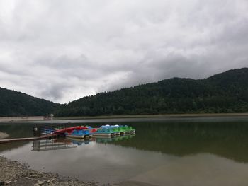 Scenic view of lake and mountains against sky