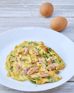 Omelet with brown eggs on table