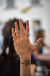 Close-up of woman covering face with hand