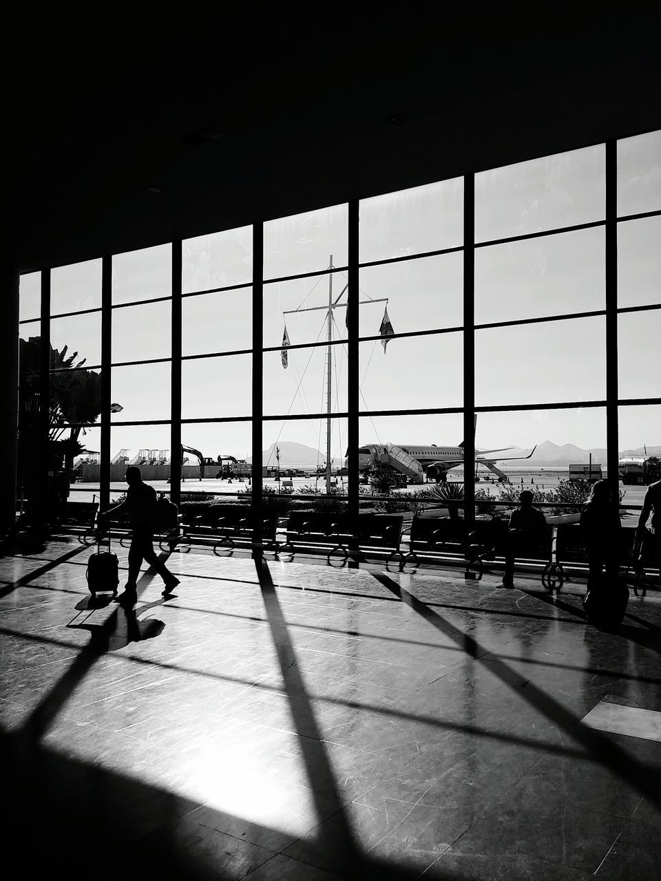 SILHOUETTE PEOPLE IN AIRPORT