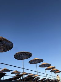 Low angle view of parasol against blue sky