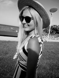 Portrait of young woman with sunglasses on beach