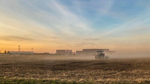 Scenic view of field against sky during sunset