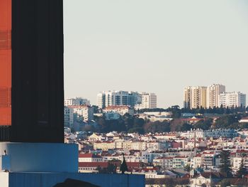 Buildings in city against clear sky