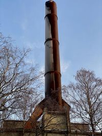 Low angle view of smoke stack against sky