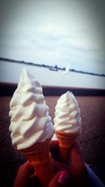 Close-up of hand holding ice cream cone