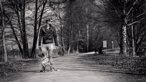 Man and dog on road in forest