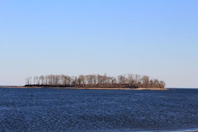 Scenic view of sea against clear blue sky