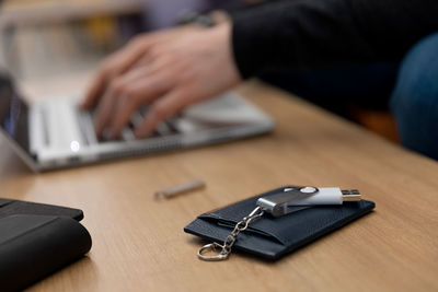 Midsection of man using mobile phone