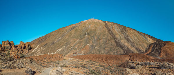 Scenic view of rocky mountains against clear blue sky