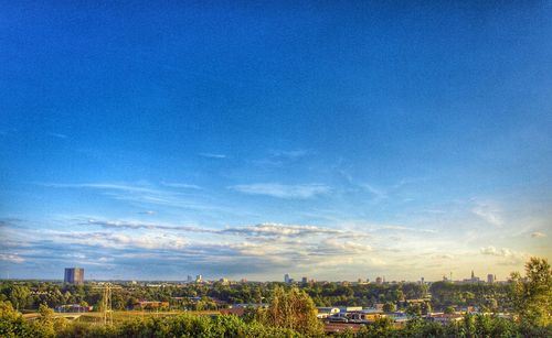 View of cityscape against blue sky