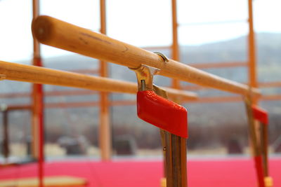Close-up of red bell hanging on railing