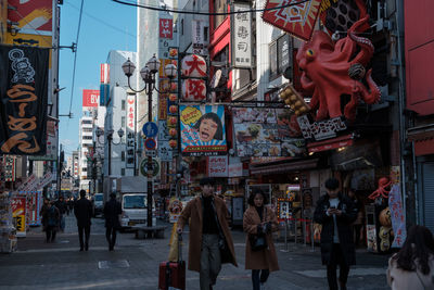 People walking on street in city