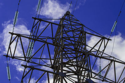 Low angle view of electricity pylon against sky