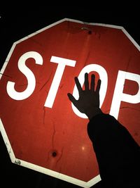 Close-up of hand on stop sign