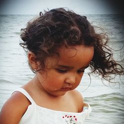 Portrait of cute girl looking at sea