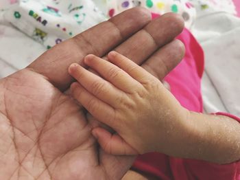 Close-up of hands holding baby hand