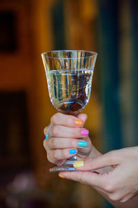 Midsection of woman holding drink glass